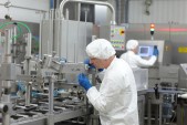 two workers at production line in plant